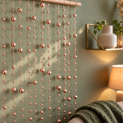 Hanging rose gold faux pearl string beads used as a decorative wall backdrop - thumbnail number 7
