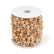 Spool of rose gold faux pearl string beads on a transparent fishing line - thumbnail number 1