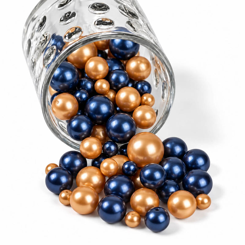 A glass jar spilling navy blue and gold pearl beads - thumbnail number 1