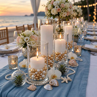 Glass cylinder vases with lit candles, filled with off-white and gold pearls on a seaside table - thumbnail number 5