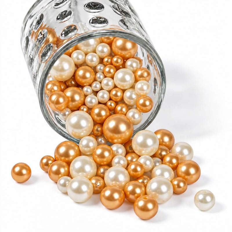 A glass jar spilling off-white and gold pearl beads - thumbnail number 1