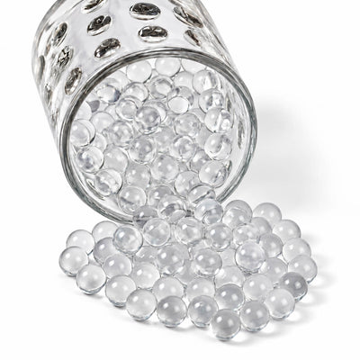 A glass jar spilling clear water gel beads - thumbnail number 1