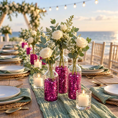 Beach wedding table setting with vases filled with metallic hot pink chunky glitter, holding white roses - thumbnail number 6