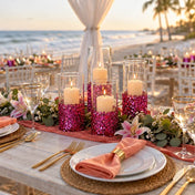 A beach wedding reception table with glass candle holders decorated with metallic hot pink chunky glitter - thumbnail number 8