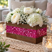 A wooden centerpiece box, accented with metallic hot pink chunky glitter, holding white flowers - thumbnail number 11