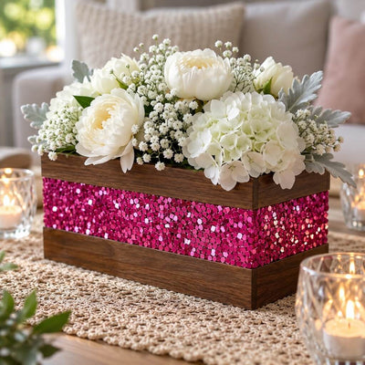 A wooden centerpiece box, accented with metallic hot pink chunky glitter, holding white flowers - thumbnail number 11