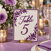 Table 5 sign with purple glitter detailing in a wedding setting - thumbnail number 3
