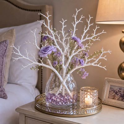 White artificial manzanita tree branches with purple flowers in a glass vase on a bedside table - thumbnail number 7