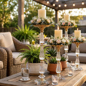 Gold and clear acrylic pillar candle stands styled with peach and white florals on patio table - thumbnail number 6