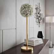 Gold metal stand topped with a white floral sphere displayed on a modern console table - thumbnail number 7