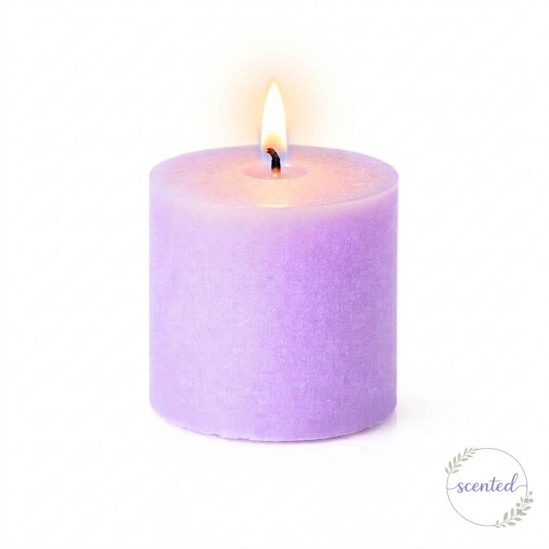 A lit lavender scented candle and a small round logo badge on white - thumbnail number 4
