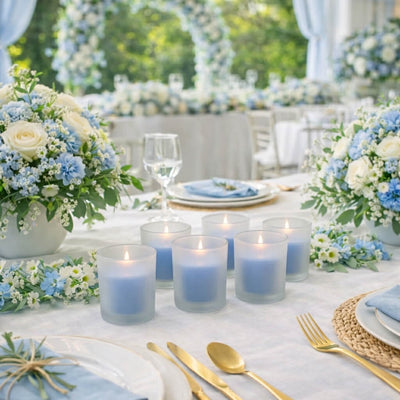 Six blue candles in Frosted Votive Holders on a wedding table setup with flowers - thumbnail number 5