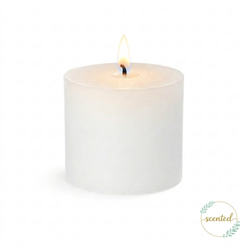A lit white votive citronella candle on a plain white background with a logo sticker - thumbnail number 4