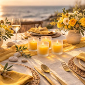 Four frosted votive holders with yellow candles on a beachside tablescape at sunset - thumbnail number 5