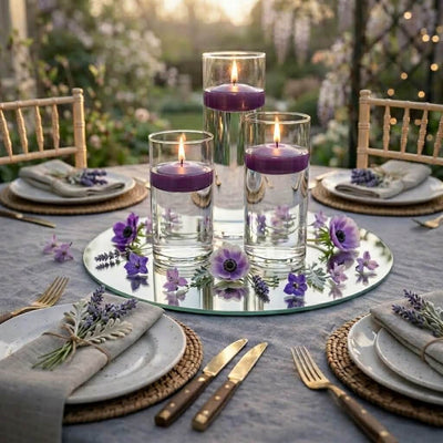 Three purple floating candles in glass cylinders on a mirrored tray with flowers - thumbnail number 4