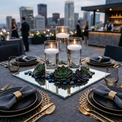 White floating candles in glass cylinders on a mirror with succulents at a rooftop event - thumbnail number 4