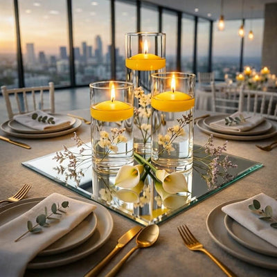 Glass cylinder vases with yellow floating candles and flowers on a square glass mirror as a centerpiece - thumbnail number 7