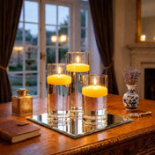 Glass cylinder vases with yellow floating candles on a mirror tray - thumbnail number 3