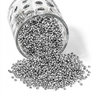 Sparkling silver faux diamond rhinestones spilling out of a glass jar onto a white background - thumbnail number 1