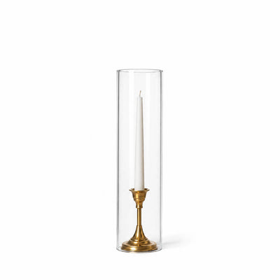 A white taper in a gold holder with a 4" x 16" chimney glass candle shade - thumbnail number 2