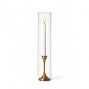 A lit white taper in a gold holder with a 4" x 18" chimney glass candle shade - thumbnail number 3