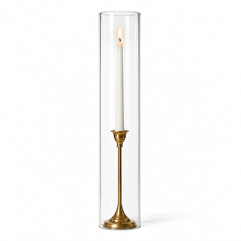 A lit white taper in a gold holder with a 4"x20" chimney glass candle shade - thumbnail number 3