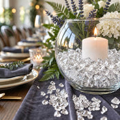 Lit white candle in a glass bowl with clear acrylic ice beads on a dark blue table runner - thumbnail number 2
