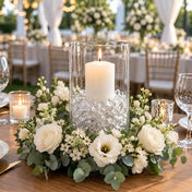 Lit white candle in a glass cylinder with clear acrylic ice beads inside a white floral wreath - thumbnail number 5