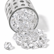 Clear acrylic ice beads spill from a textured glass jar onto a clean white surface - thumbnail number 1
