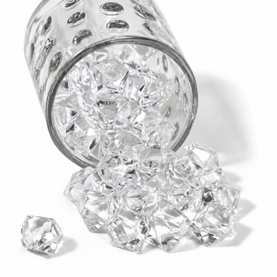 Clear acrylic ice beads spill from a textured glass jar onto a clean white surface - thumbnail number 1