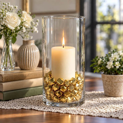 Tall glass cylinder candle holder filled with gold acrylic ice beads and a lit candle - thumbnail number 7