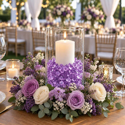 Lit white candle in a glass cylinder with purple acrylic ice beads inside a purple floral wreath - thumbnail number 3