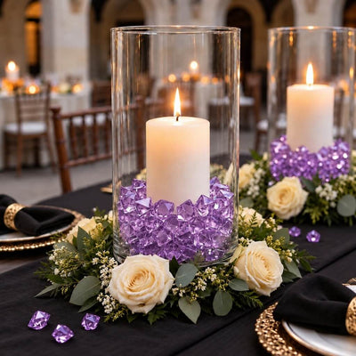 Lit white candles in glass cylinders filled with purple acrylic ice beads on a floral centerpiece - thumbnail number 6