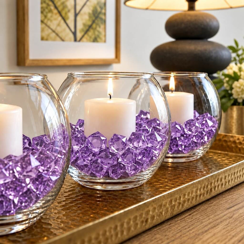Lit candles in round glass bowls filled with purple acrylic ice beads on a golden tray - thumbnail number 7