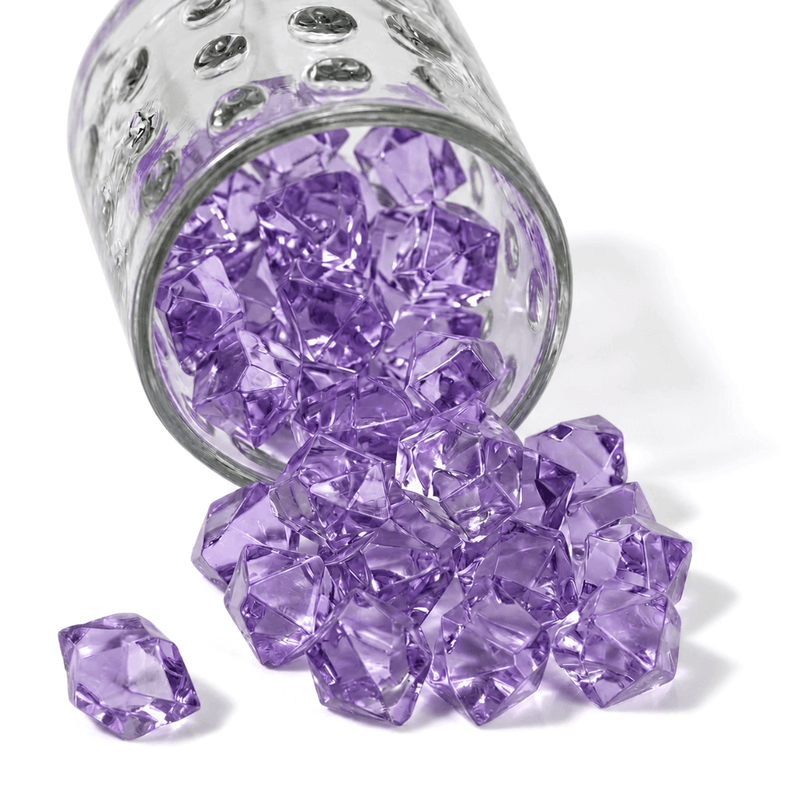 Lavender acrylic ice beads spill from a textured glass jar onto a clean white surface - thumbnail number 1