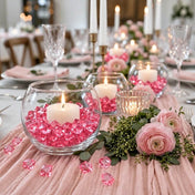 Lit white candles in glass bowls filled with pink acrylic ice beads on a pink runner table centerpiece - thumbnail number 3