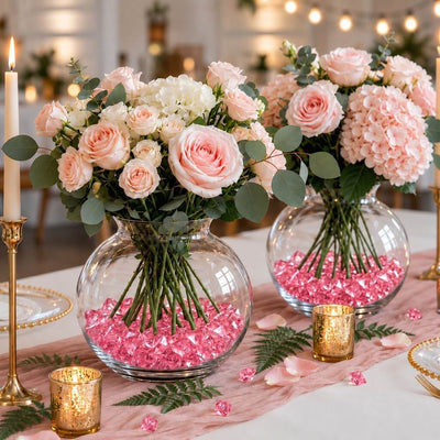 Pink floral arrangements in round glass vases filled with pink acrylic ice beads on a table - thumbnail number 6