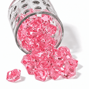 Pink acrylic ice beads spilling out of a textured clear glass jar onto a white background - thumbnail number 1