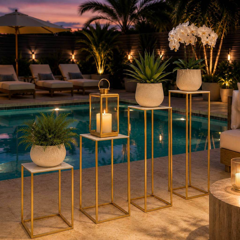 Four white acrylic square tops on gold stands with plants and a candle by a pool - thumbnail number 8