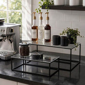 Clear acrylic and black metal display stands on a kitchen counter holding coffee bar accessories - thumbnail number 8