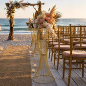 36-inch gold metal stands with floral arrangements lining a beach wedding aisle - thumbnail number 3