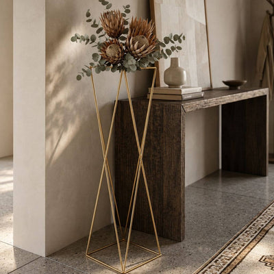 Tall gold geometric stand with protea flowers in entryway - thumbnail number 9