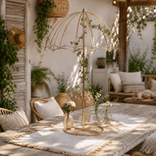 Gold metal umbrella flower stand centerpiece with minimal green vines on an outdoor patio table - thumbnail number 7