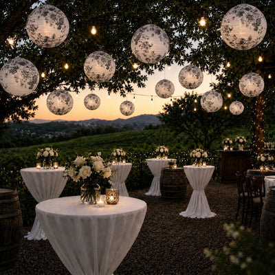 Black and white French toile paper lanterns hanging over an outdoor vineyard reception - thumbnail number 6