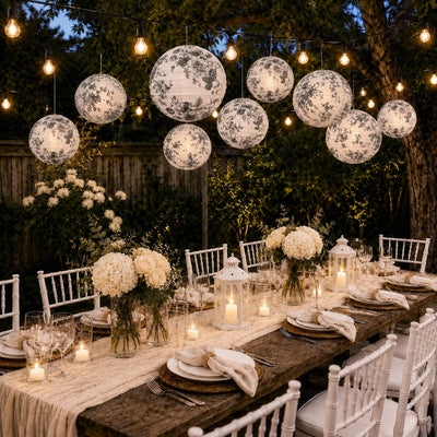 Black and white French toile paper lanterns hanging over outdoor dining table - thumbnail number 7