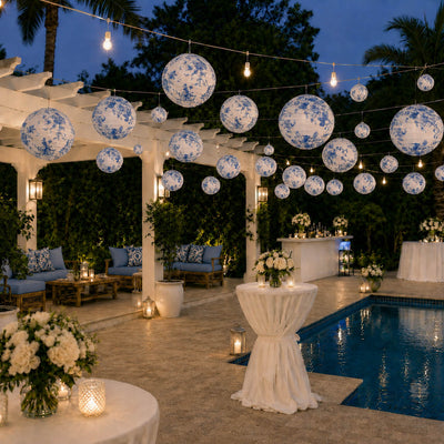 Blue floral paper lanterns hang over a poolside patio venue - thumbnail number 5