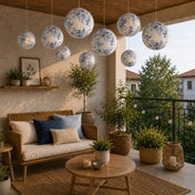 Blue floral paper lanterns hang above a cozy apartment balcony seating area - thumbnail number 11