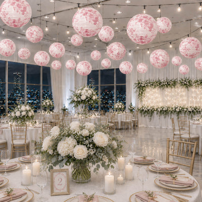 Pink floral paper lanterns hang over an elegant wedding reception ballroom - thumbnail number 3