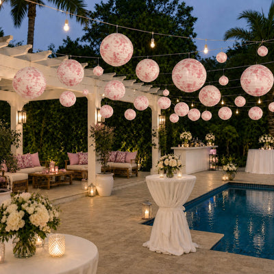 Pink floral paper lanterns hang over a poolside patio venue - thumbnail number 5