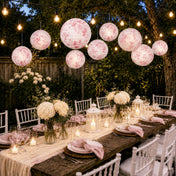 Pink floral French toile paper lanterns lit over an outdoor dining table - thumbnail number 7